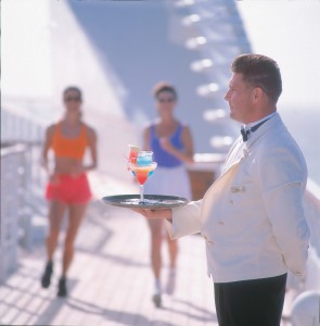 PSLSSM03 profile of white jacket server holds tray of cocktails joggers blurred in background